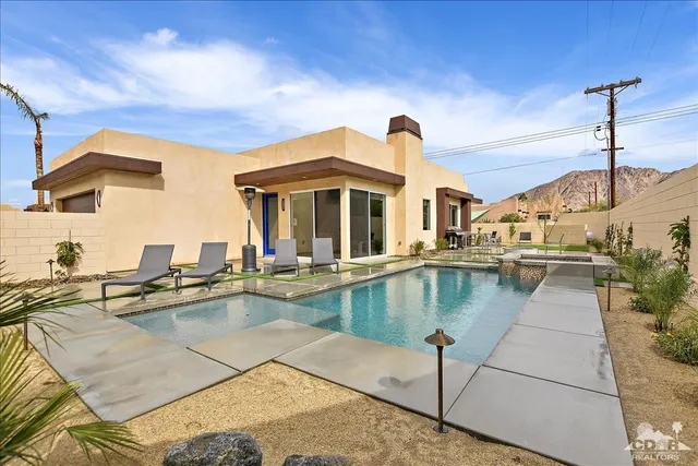 a view of a swimming pool with a lounge chairs