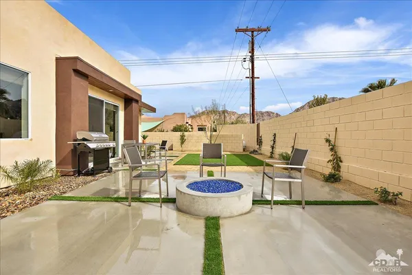 a view of a swimming pool with a table and chairs