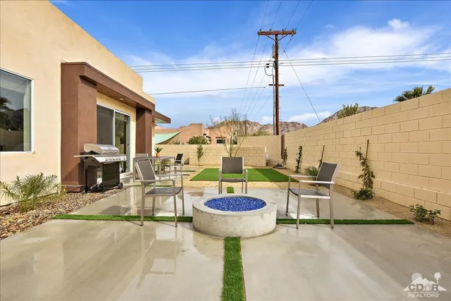 a view of a swimming pool with a table and chairs