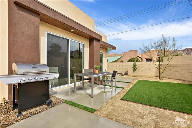 a view of outdoor kitchen with seating area