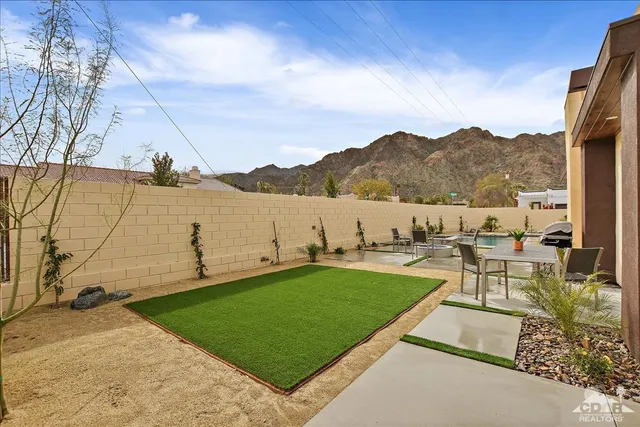 a view of a lake with a table and chairs