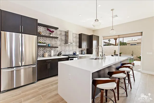 a kitchen with stainless steel appliances a sink and a refrigerator