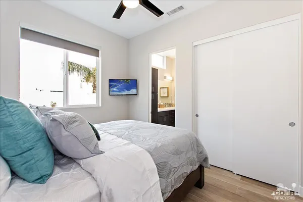 a bedroom with a bed and a window