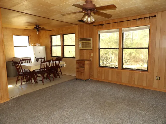 a kitchen with a stove a sink a dining table and chairs