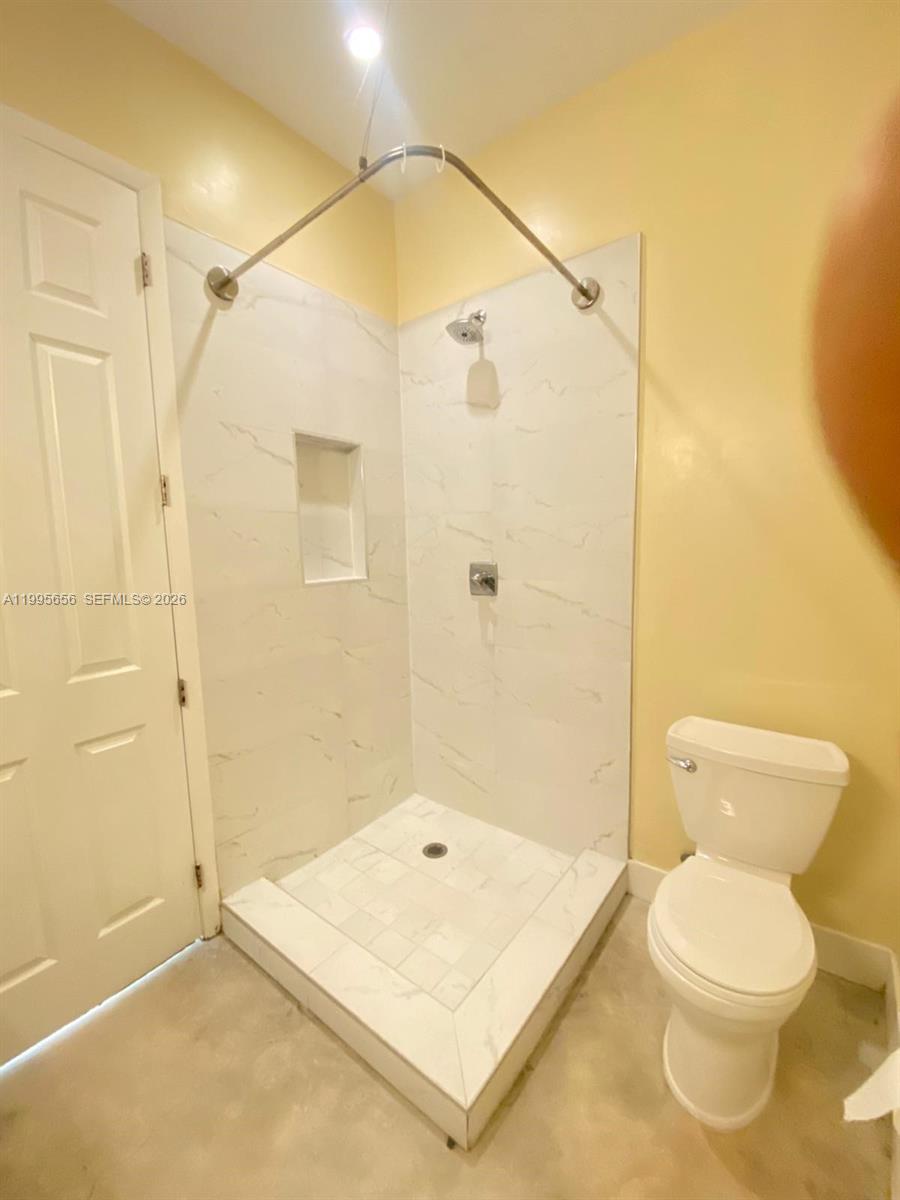 12150 Southwest 213th Street, Unit 12150 Miami, FL 33177 - Photo 16 of 16 a bathroom with a shower a toilet and a shower