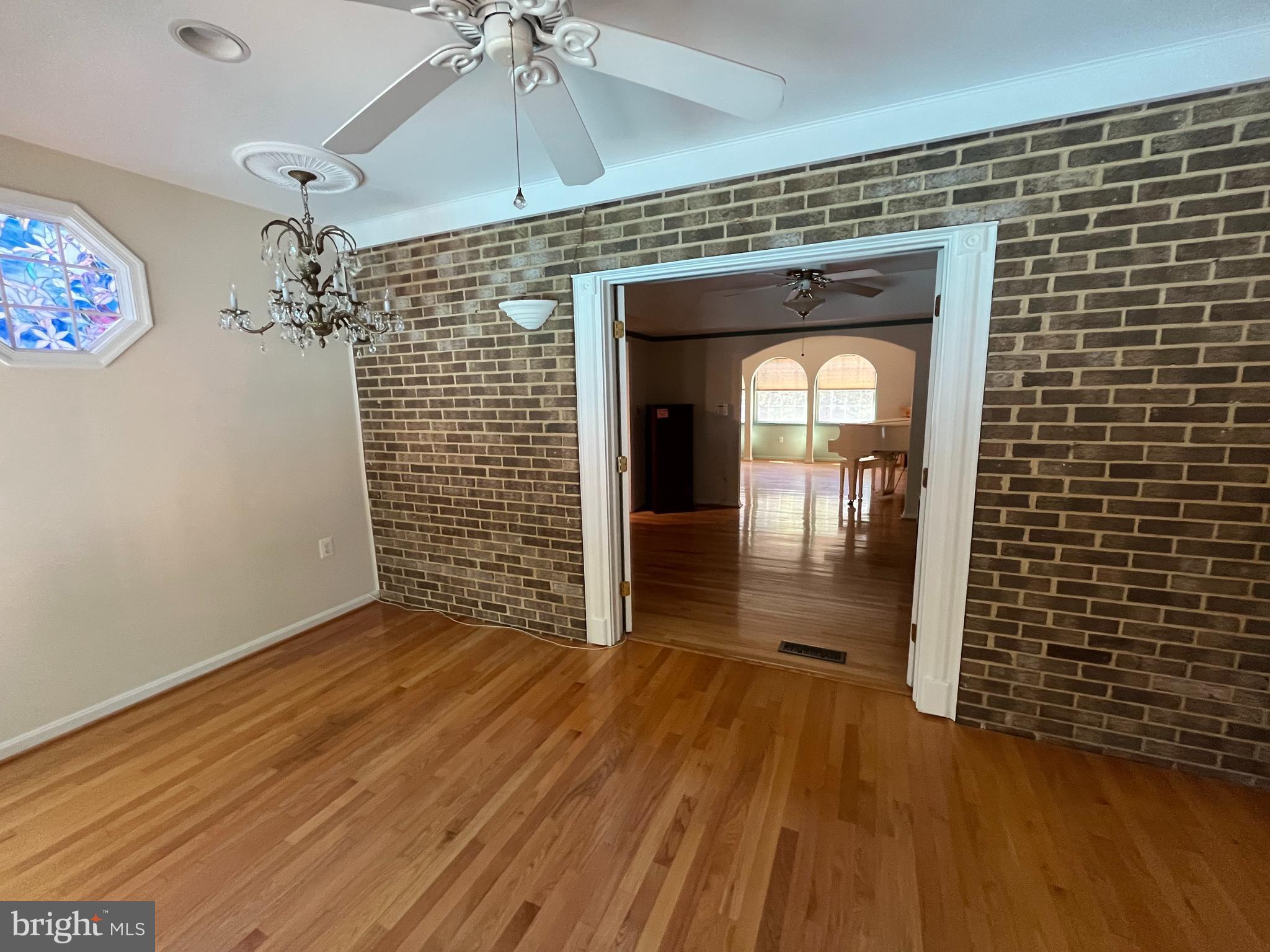 3203 Riverview Drive Triangle, VA 22172 - Photo 12 of 78 a view of a hallway with wooden floor and a ceiling fan