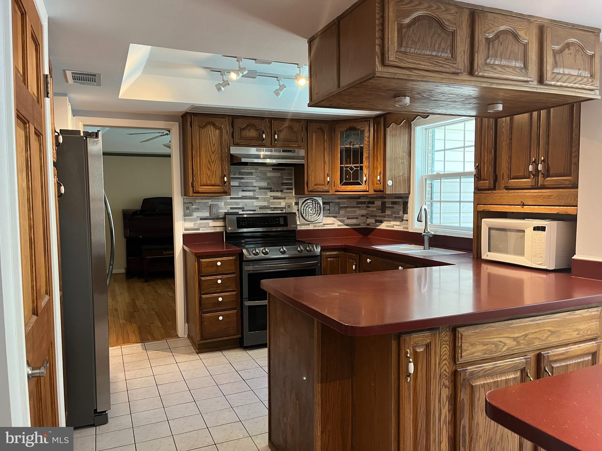 3203 Riverview Drive Triangle, VA 22172 - Photo 19 of 78 a kitchen with stainless steel appliances granite countertop a stove and a refrigerator