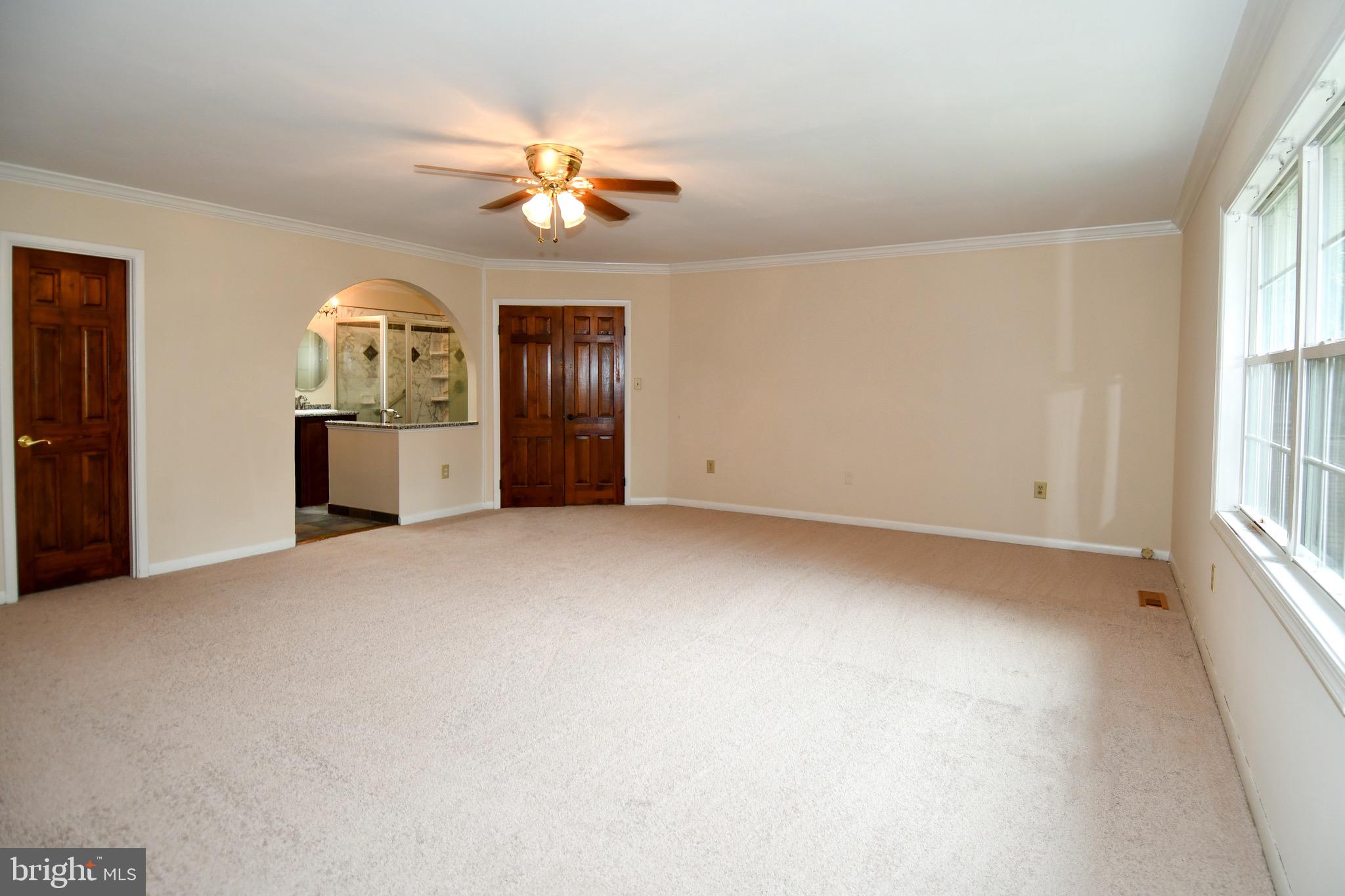 3203 Riverview Drive Triangle, VA 22172 - Photo 24 of 78 an empty room with chandelier fan and windows