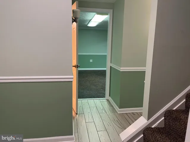 a bathroom with a granite countertop toilet sink and mirror
