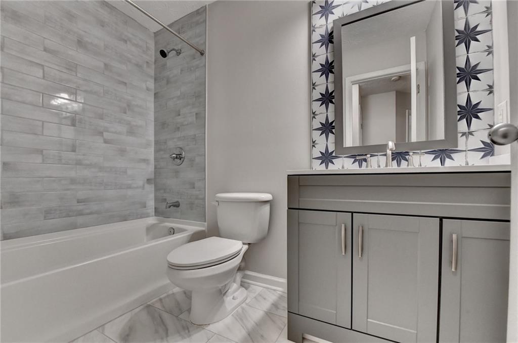 310 Andrew Ridge Drive Jefferson, GA 30549 - Photo 43 of 52 a bathroom with a sink vanity mirror toilet and bathtub
