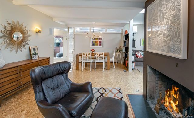 a dining room with furniture and a floor to ceiling window