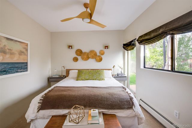 a bed sitting in a bedroom next to a window