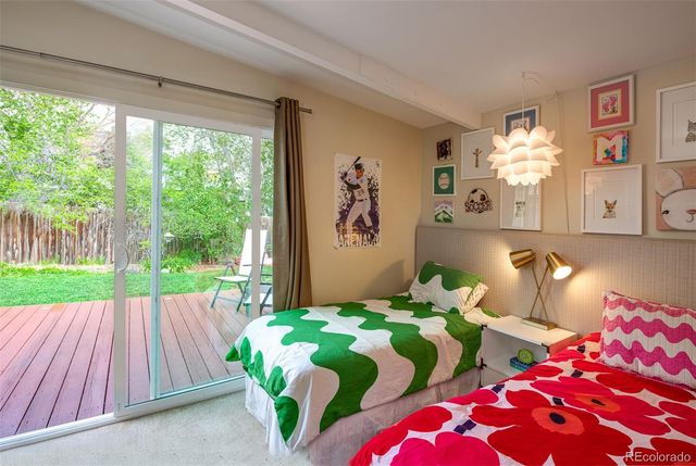 a bedroom with two beds and a large window