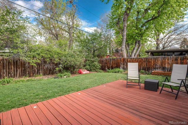 a view of a backyard with sitting area