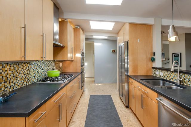 a kitchen with sink and refrigerator