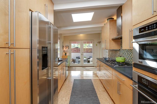 a kitchen with stainless steel appliances a refrigerator and a stove