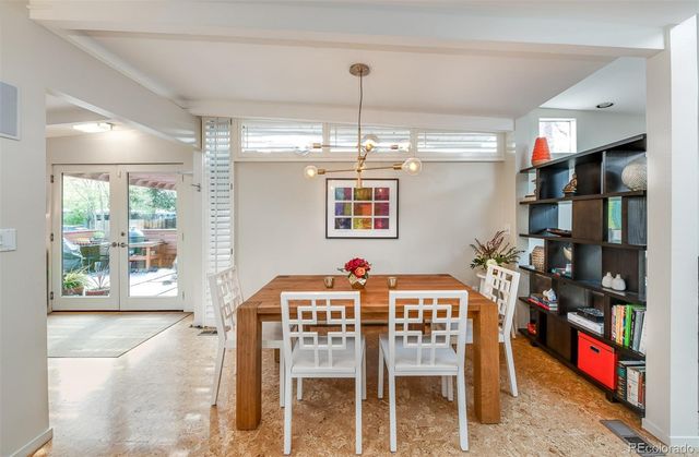 a view of a dining room with furniture and chandelier