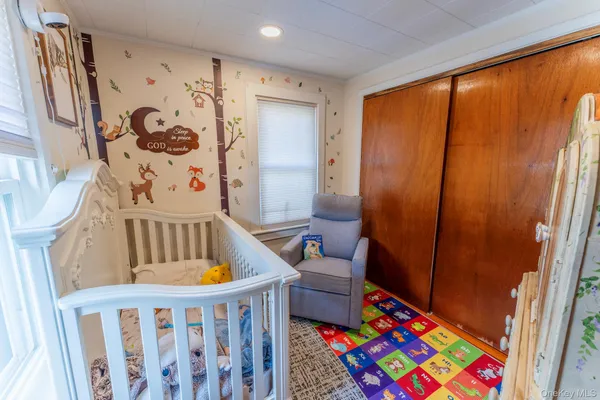 a bedroom with furniture and a baby crib