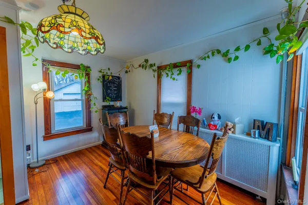 a view of a dining room with furniture one side kitchen view