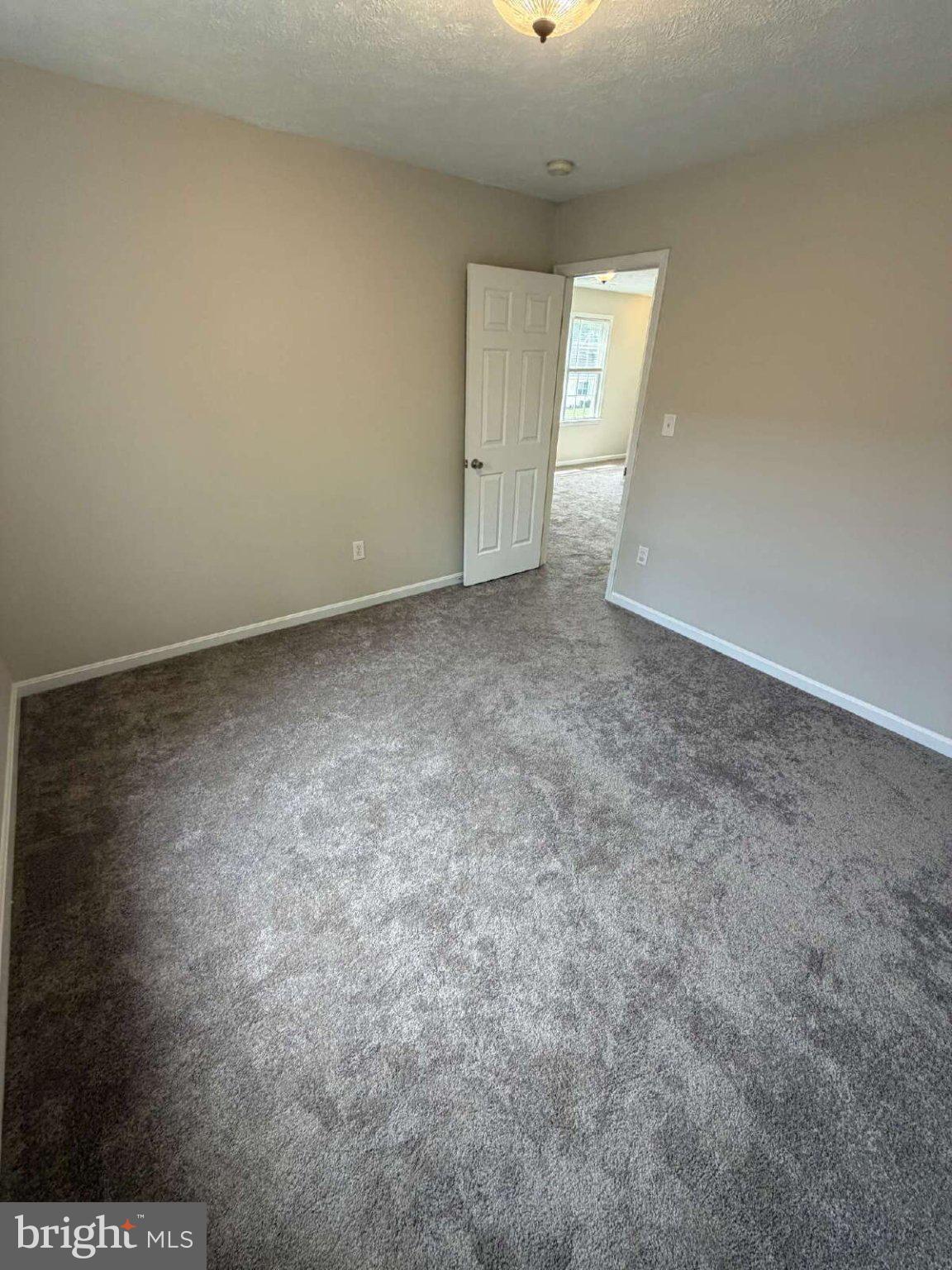 313 3rd Street Colonial Beach, VA 22443 - Photo 16 of 36 Spacious room with soft carpet charm.