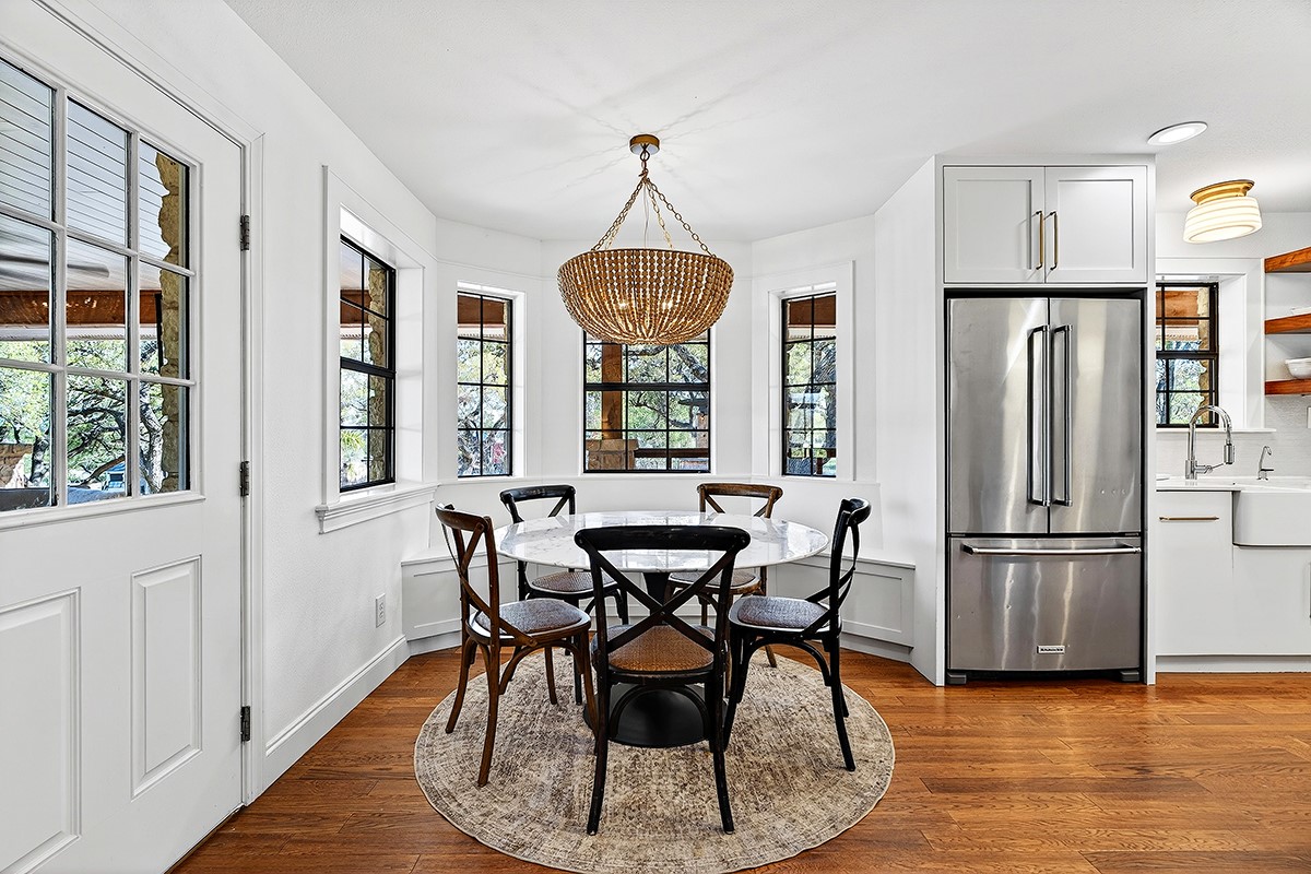301 Medlin Creek Loop Dripping Springs, TX 78620 - Photo 12 of 40 a dining room with furniture a chandelier and wooden floor
