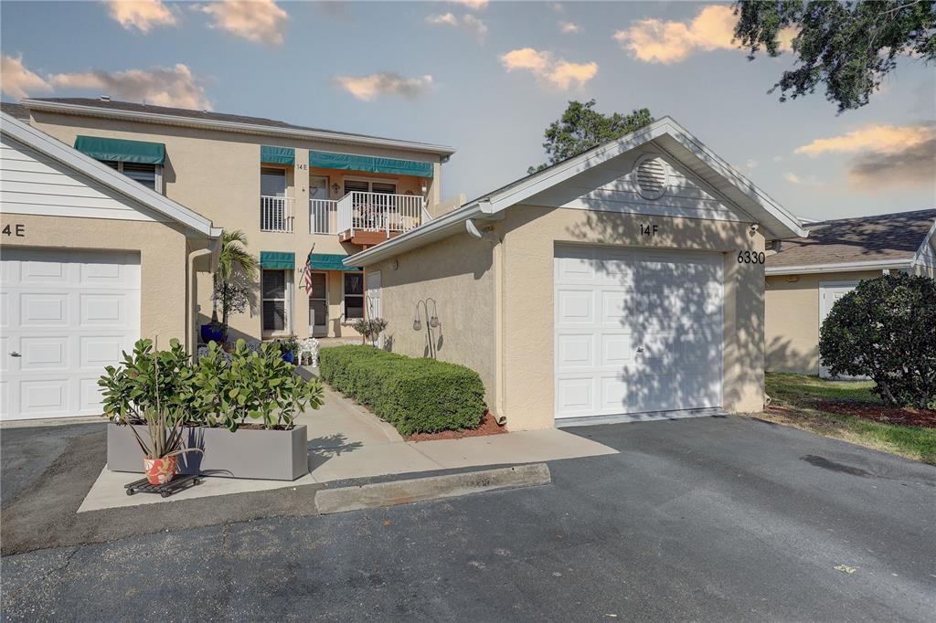 6330 99th Way North, Unit 14F St. Petersburg, FL 33708 - Photo 1 of 1 front view of a house with a street
