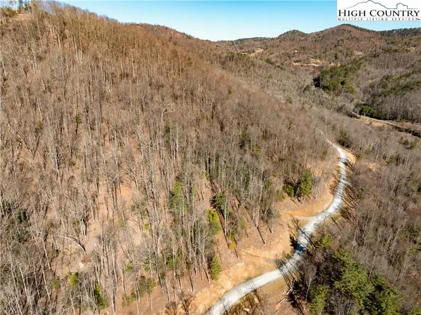 a view of a dry yard with mountains in the background