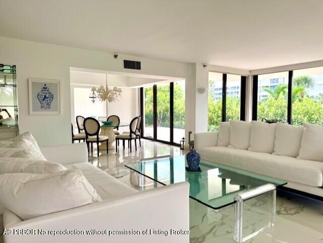2580 South Ocean Boulevard, Unit 1A1 Palm Beach, FL 33480 - Photo 1 of 24 a living room with furniture and floor to ceiling windows