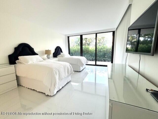 2580 South Ocean Boulevard, Unit 1A1 Palm Beach, FL 33480 - Photo 11 of 24 a bedroom with double bed and a large window