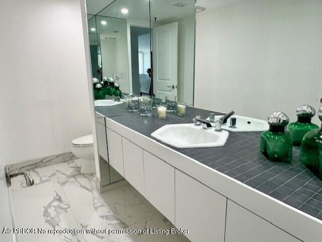 2580 South Ocean Boulevard, Unit 1A1 Palm Beach, FL 33480 - Photo 13 of 24 a bathroom with a sink and mirror