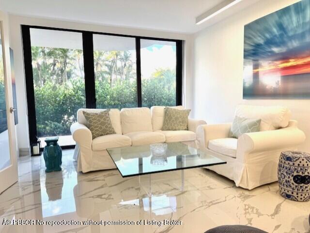 2580 South Ocean Boulevard, Unit 1A1 Palm Beach, FL 33480 - Photo 3 of 24 a living room with furniture and a large window