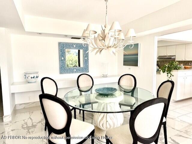 2580 South Ocean Boulevard, Unit 1A1 Palm Beach, FL 33480 - Photo 4 of 24 a table and chairs in a room