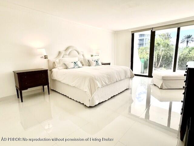 2580 South Ocean Boulevard, Unit 1A1 Palm Beach, FL 33480 - Photo 8 of 24 a bedroom with a bed chair and a large window