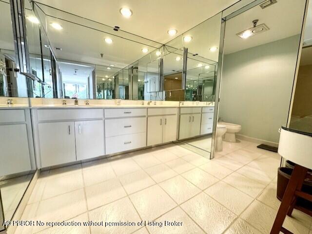 2580 South Ocean Boulevard, Unit 1A1 Palm Beach, FL 33480 - Photo 10 of 24 a large bathroom with a sink mirror and a bath tub