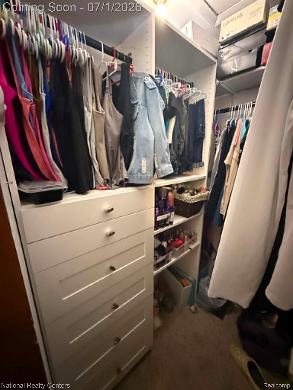 1330 Brauer Road Oxford, MI 48371 - Photo 50 of 54 Custom closet system featuring multiple hanging rods, integrated shelving, and a five-drawer dresser unit