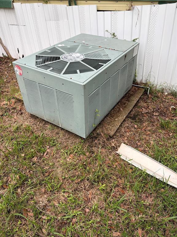 410 Patrick Street Minden, LA 71055 - Photo 9 of 9 Exterior HVAC unit on a concrete pad, surrounded by a grassy area and backed by a white fence