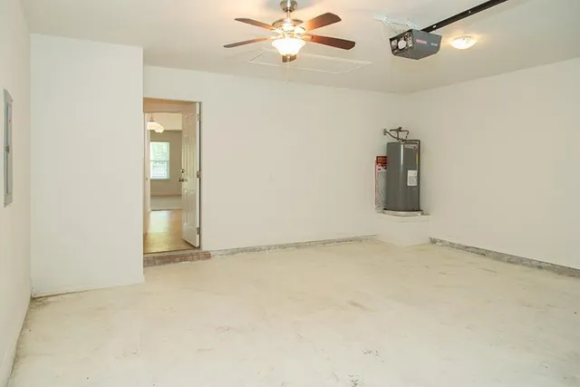 an empty room with closet and a chandelier fan