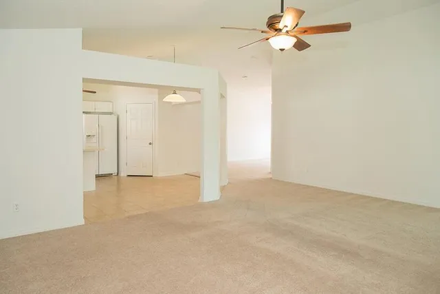 an empty room with fan and a ceiling fan