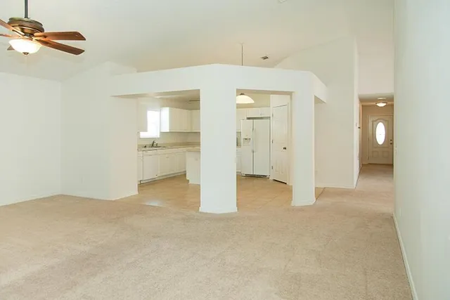 an empty room with a bathroom and mirror