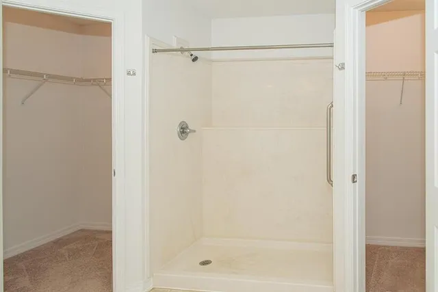 a bathroom with a glass shower door
