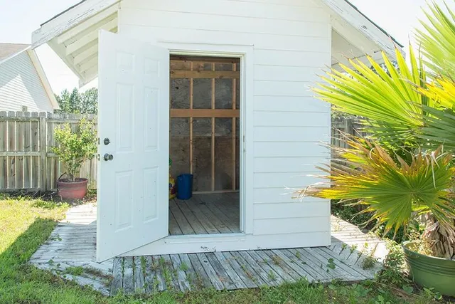 a view of a backyard with wooden fence