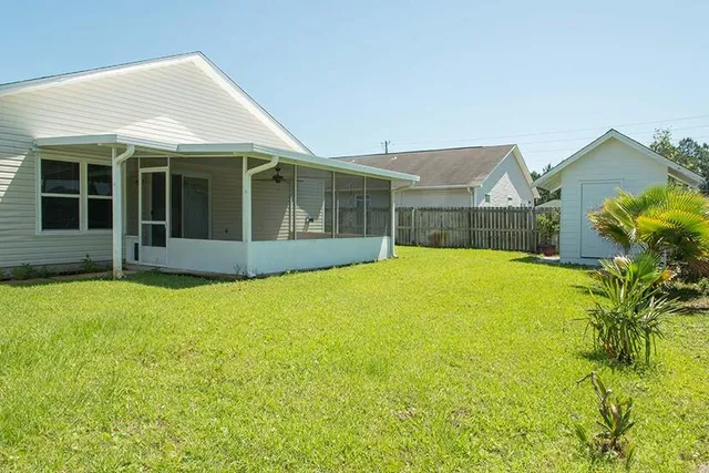 a view of an house with backyard space and garden