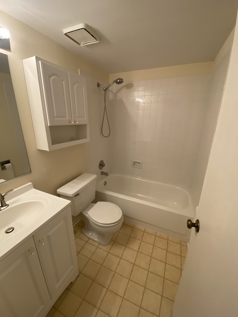 309 Memory Lane, Unit 1 Westmont, IL 60559 - Photo 16 of 23 a bathroom with a sink a toilet and shower