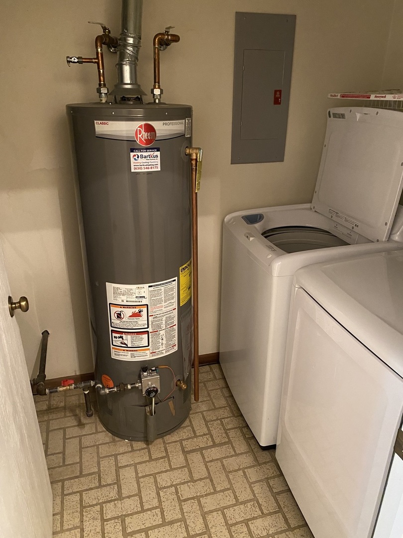 309 Memory Lane, Unit 1 Westmont, IL 60559 - Photo 18 of 23 a room with water heater and a wooden door