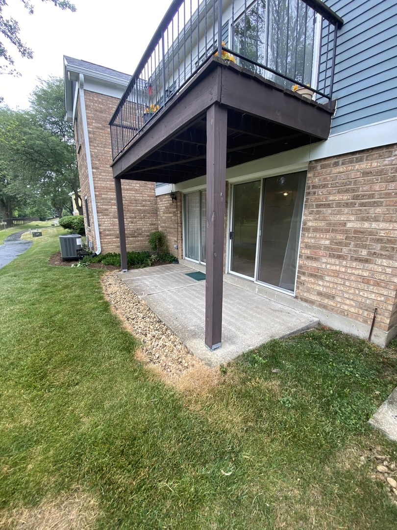 309 Memory Lane, Unit 1 Westmont, IL 60559 - Photo 20 of 23 a view of a house with a small yard and wooden fence