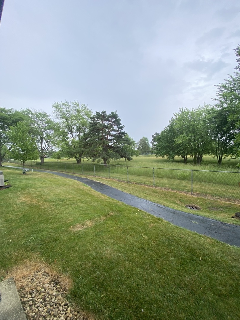 309 Memory Lane, Unit 1 Westmont, IL 60559 - Photo 21 of 23 a view of a golf course with a lake