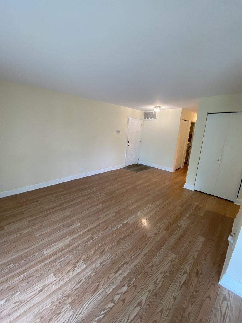 309 Memory Lane, Unit 1 Westmont, IL 60559 - Photo 8 of 23 a view of a room with wooden floor