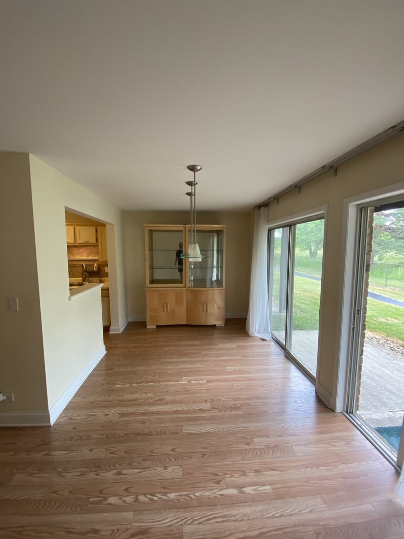 309 Memory Lane, Unit 1 Westmont, IL 60559 - Photo 9 of 23 a view of an empty room with a window and fireplace