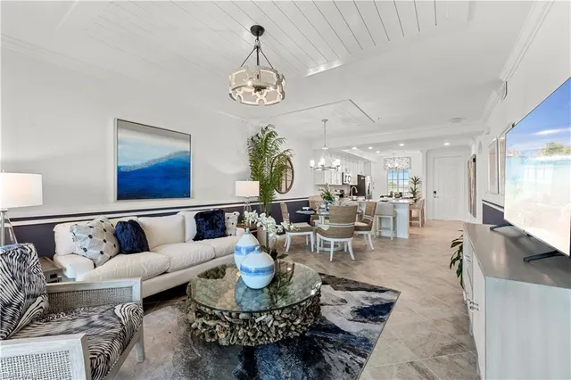 a living room with lots of furniture and view of kitchen