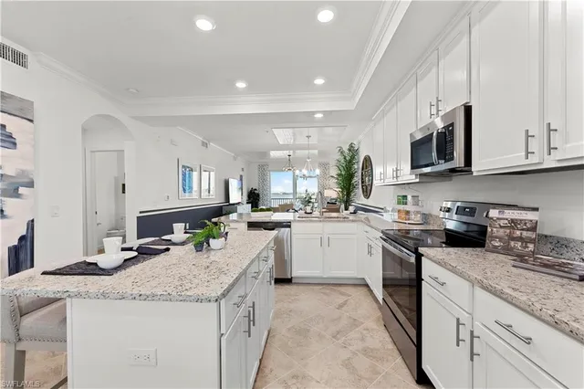 a kitchen with granite countertop kitchen island and stainless steel appliances
